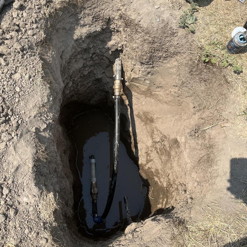 Backflow valves and underground water service piping in trench