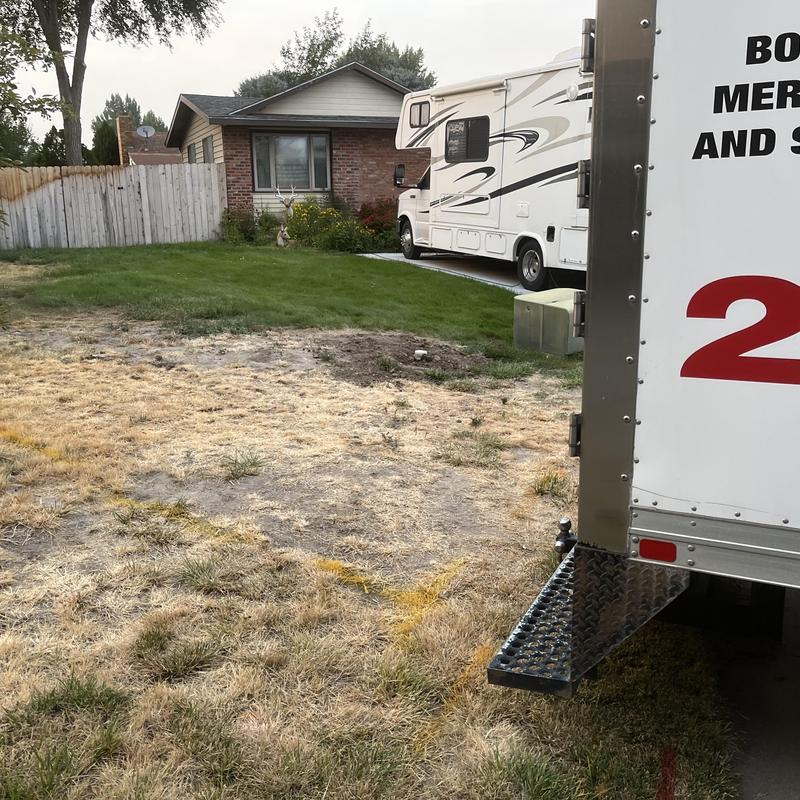 Backflow valve installation site with work truck nearby