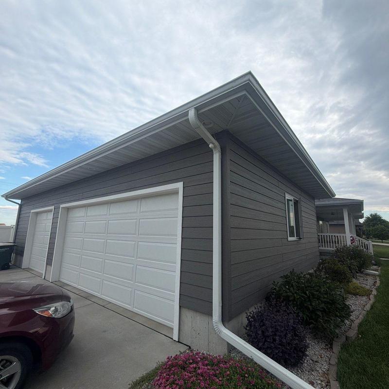 Gutter system and downspout on residential home exterior Gutter system and downspout on residential home exterior