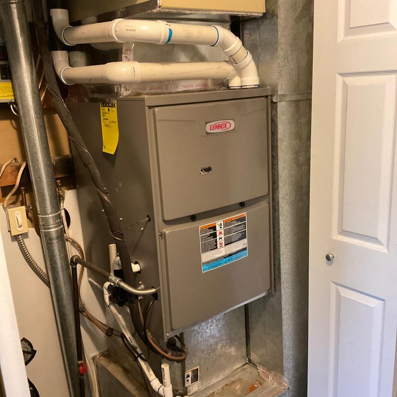 Lennox furnace with PVC exhaust pipes in basement closet
