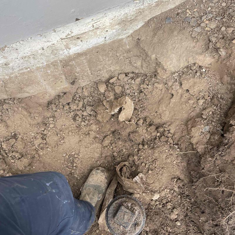 Cast iron pipe excavation at home foundation repair site