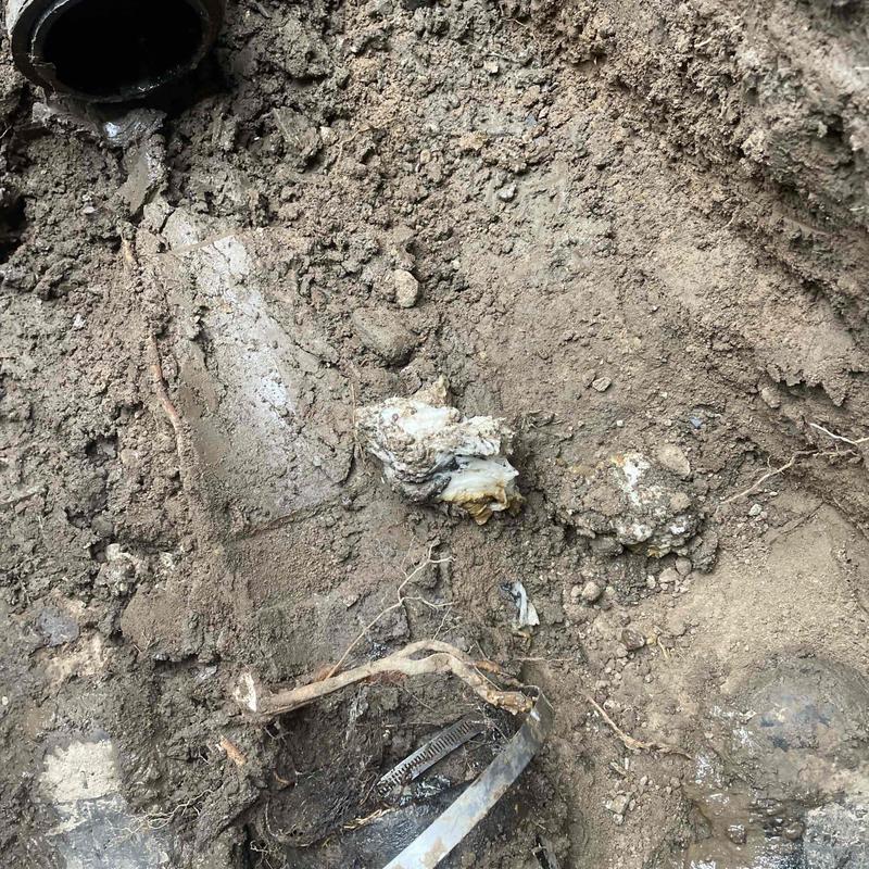 Cast iron pipe excavation and repair at foundation
