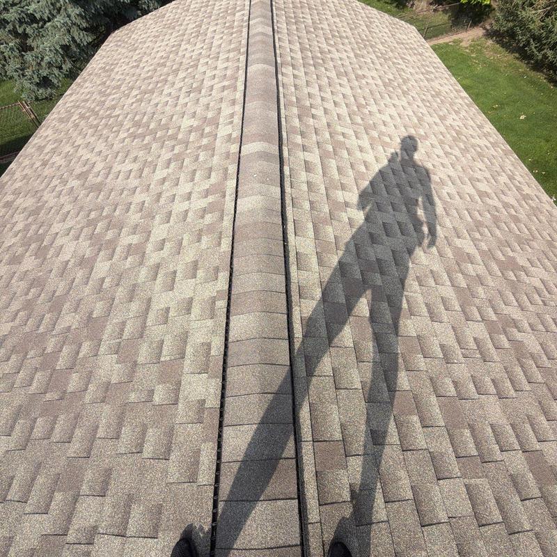 Asphalt shingle roof with ridge vent inspection shadow Asphalt shingle roof with ridge vent inspection shadow