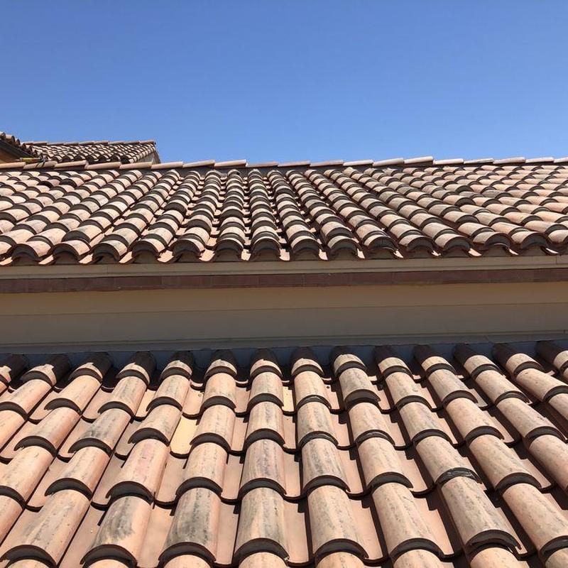Tile roof with curved terra cotta tiles under clear sky Tile roof with curved terra cotta tiles under clear sky