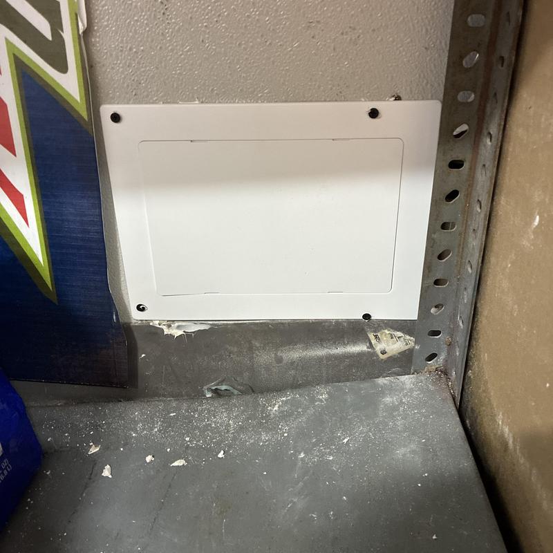 Condensation line access panel installed in wall corner Condensation line access panel installed in wall corner