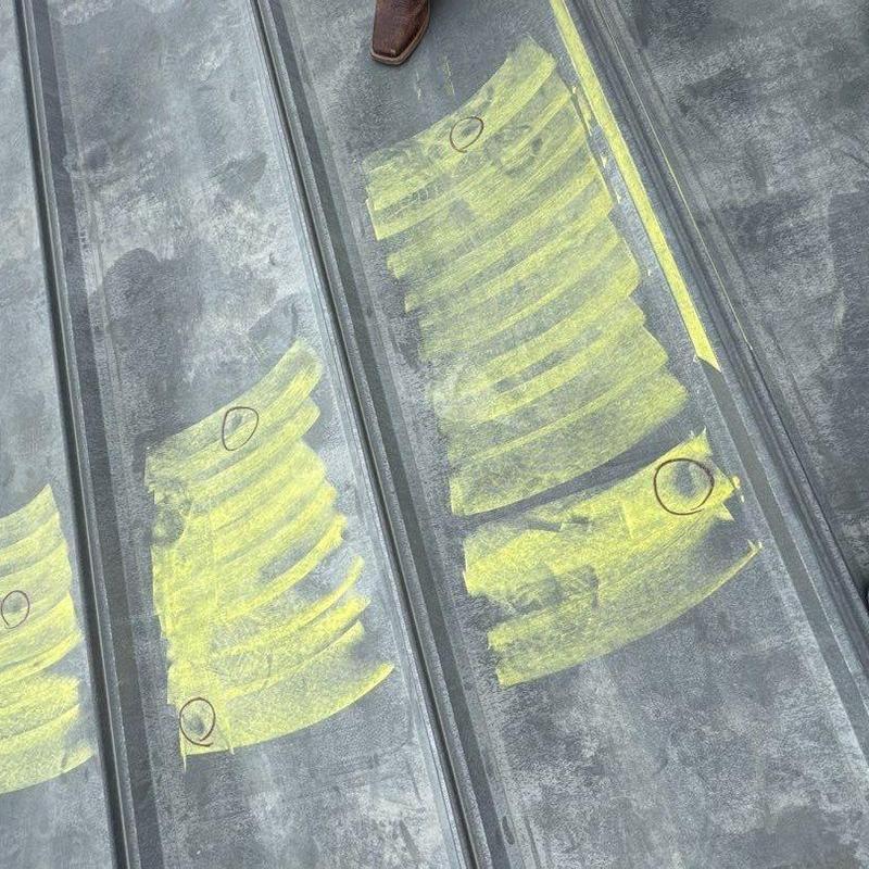 Metal roof panels marked for hail damage inspection