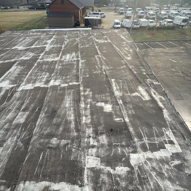 Commercial flat roof showing hail damage and wear