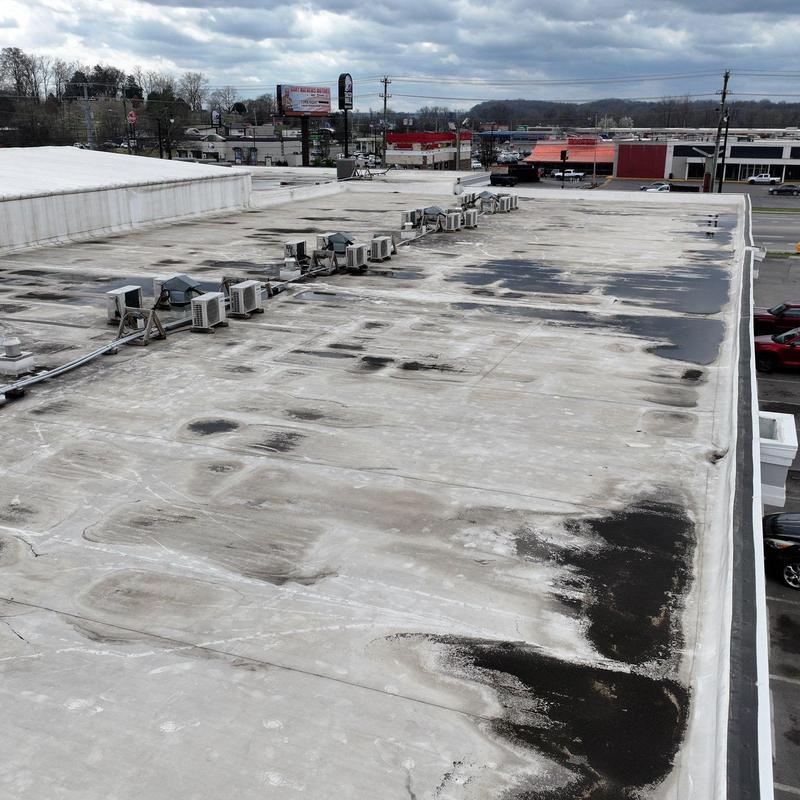 Commercial roofing with hail damage and wear marks