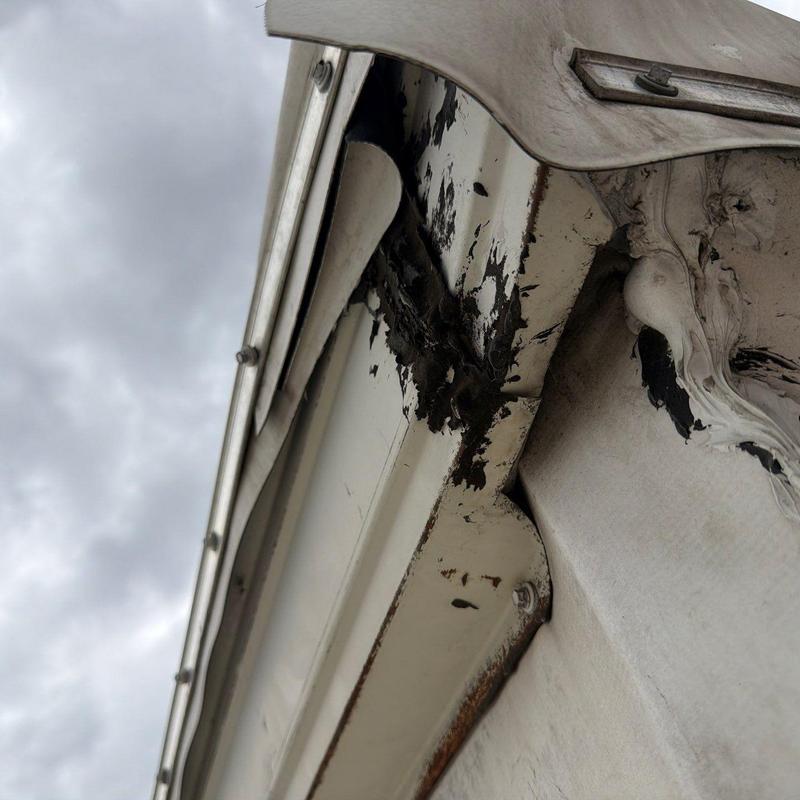 Metal flashing corrosion and paint peeling on roof edge