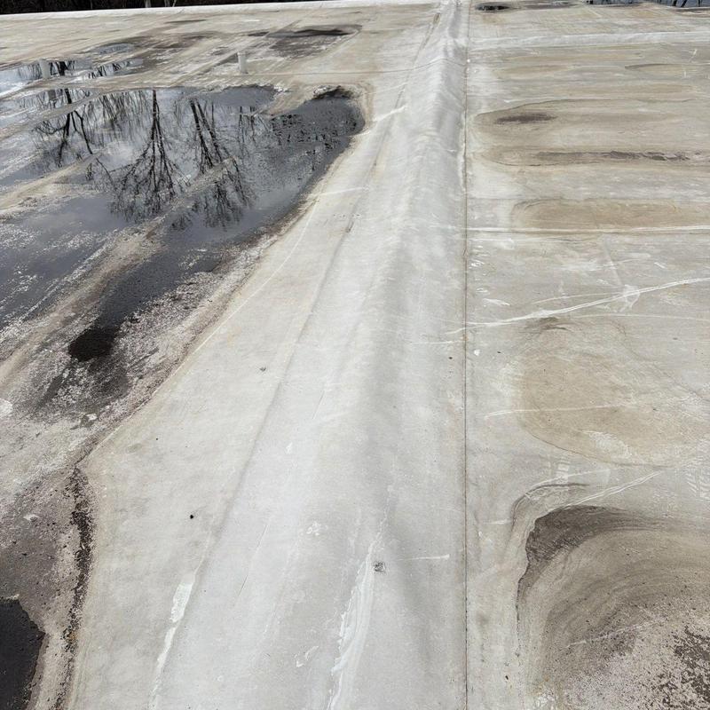 Commercial flat roof membrane with ponding water and damage