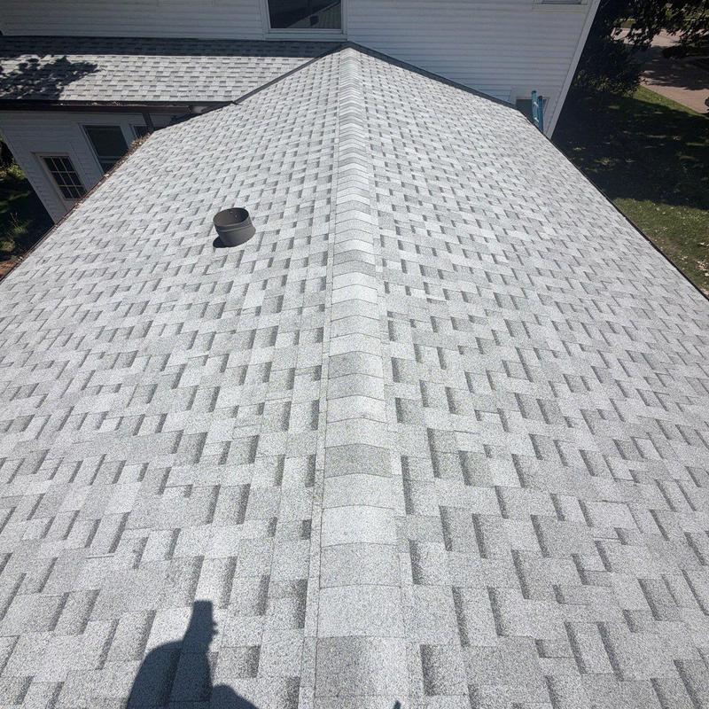 Asphalt shingle roof with vent pipe and ridge cap Asphalt shingle roof with vent pipe and ridge cap