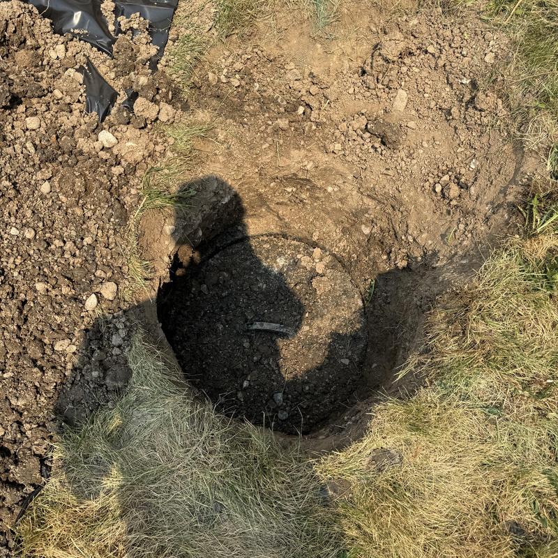 Septic tank excavation revealing drain field issue