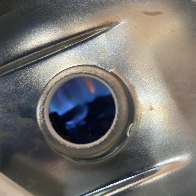 Water heater burner flame inside metal housing Water heater burner flame inside metal housing