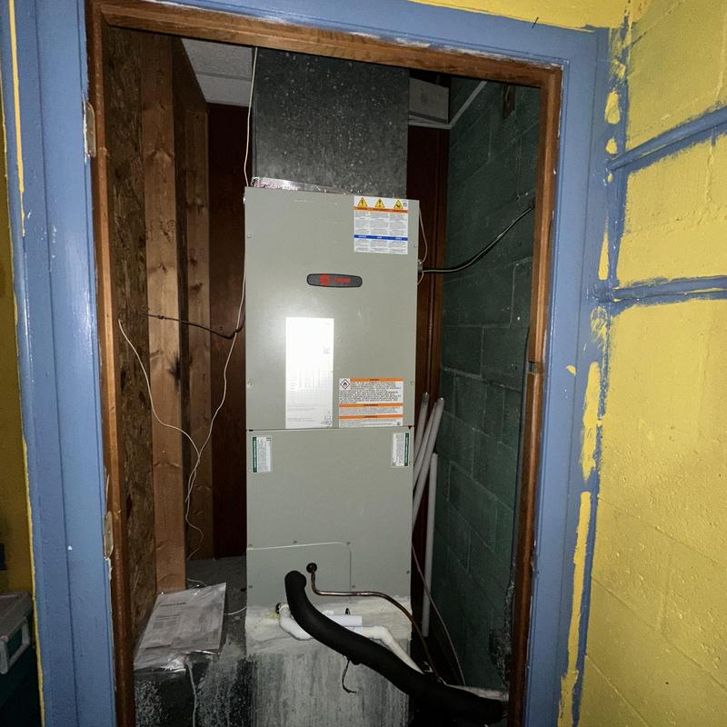 Trane heat pump air handler installed in utility room