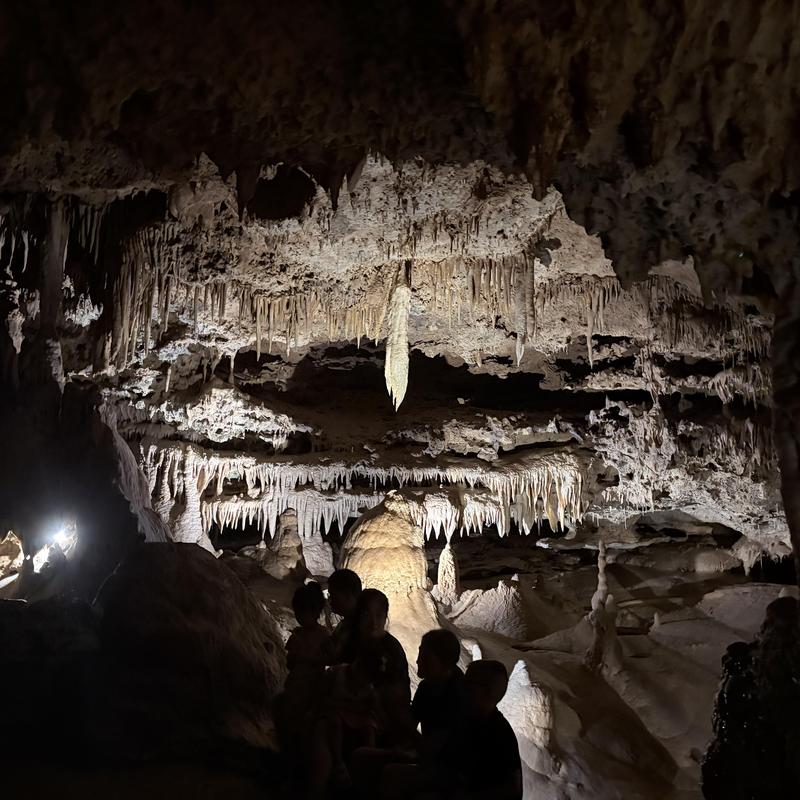 Stalactites and stalagmites inside a dimly lit cave Stalactites and stalagmites inside a dimly lit cave