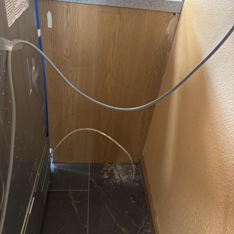 Refrigerator waterline tubing installed under kitchen floor