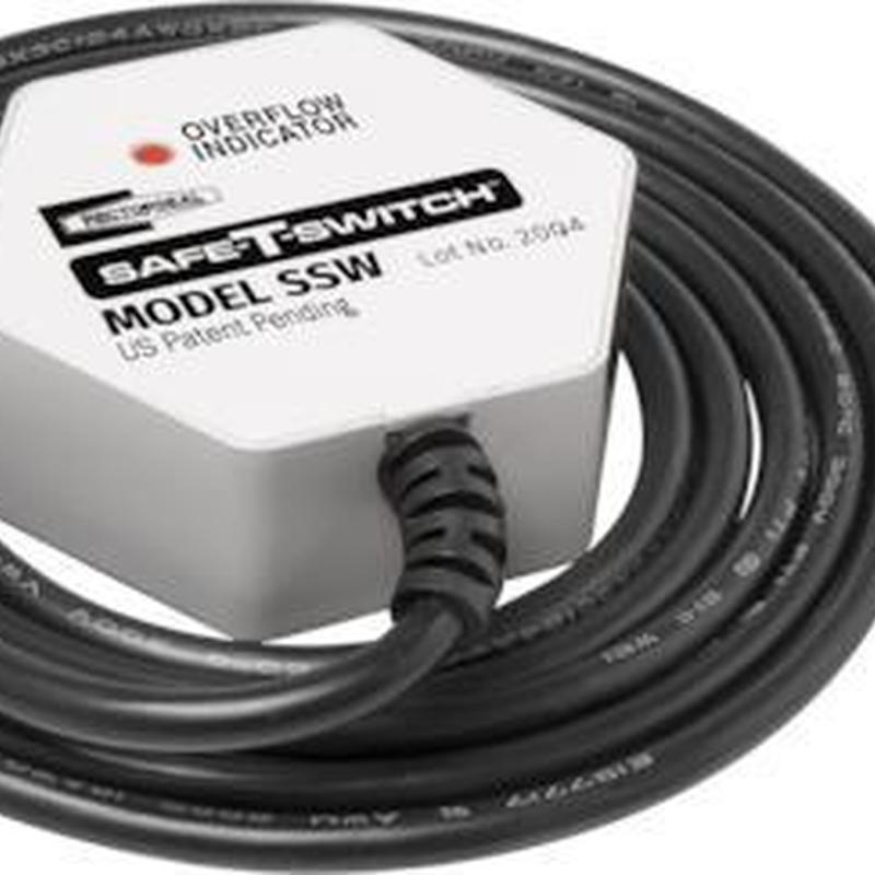 Wet switch with attached black cable coil close-up