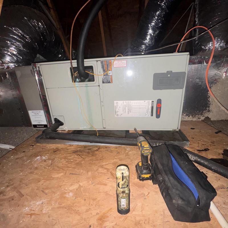 Trane heat pump air handler with tools in attic