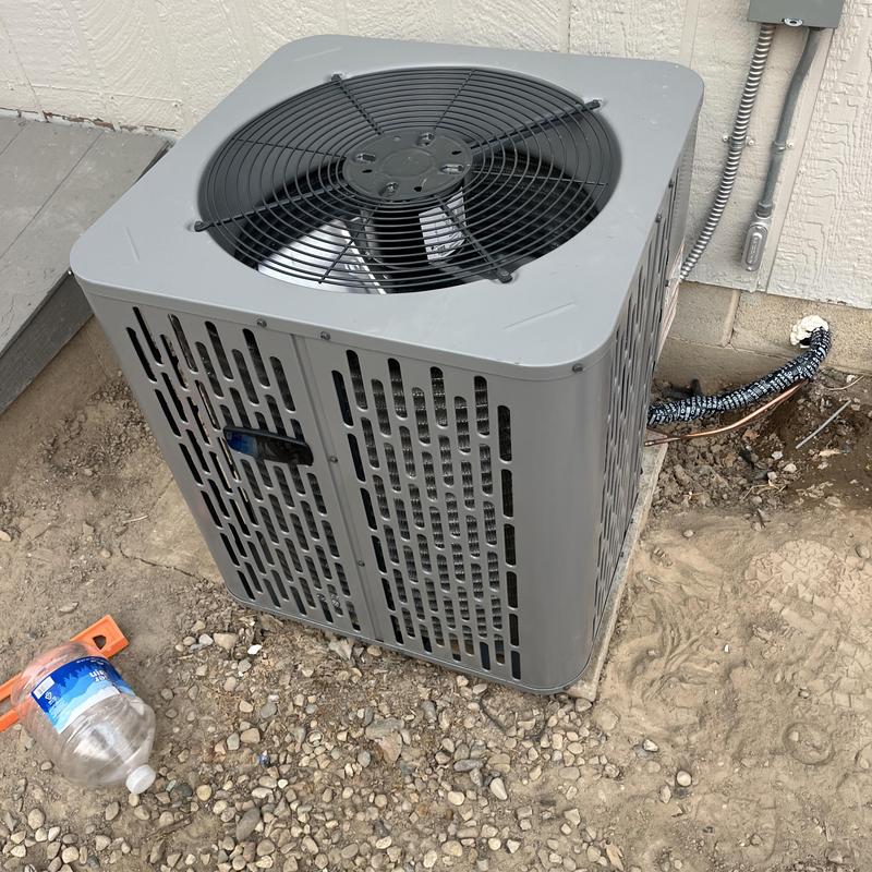 Air conditioner condenser unit installed by house exterior Air conditioner condenser unit installed by house exterior