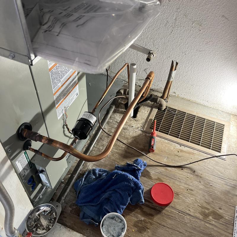 Air handler unit with copper piping and tools in basement Air handler unit with copper piping and tools in basement