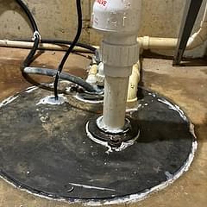Primary sump pump cover with PVC discharge pipe
