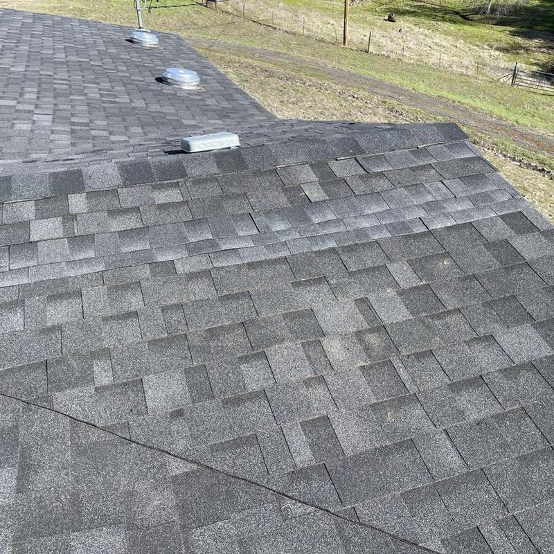 Asphalt shingle roof with ventilation caps in Jamestown