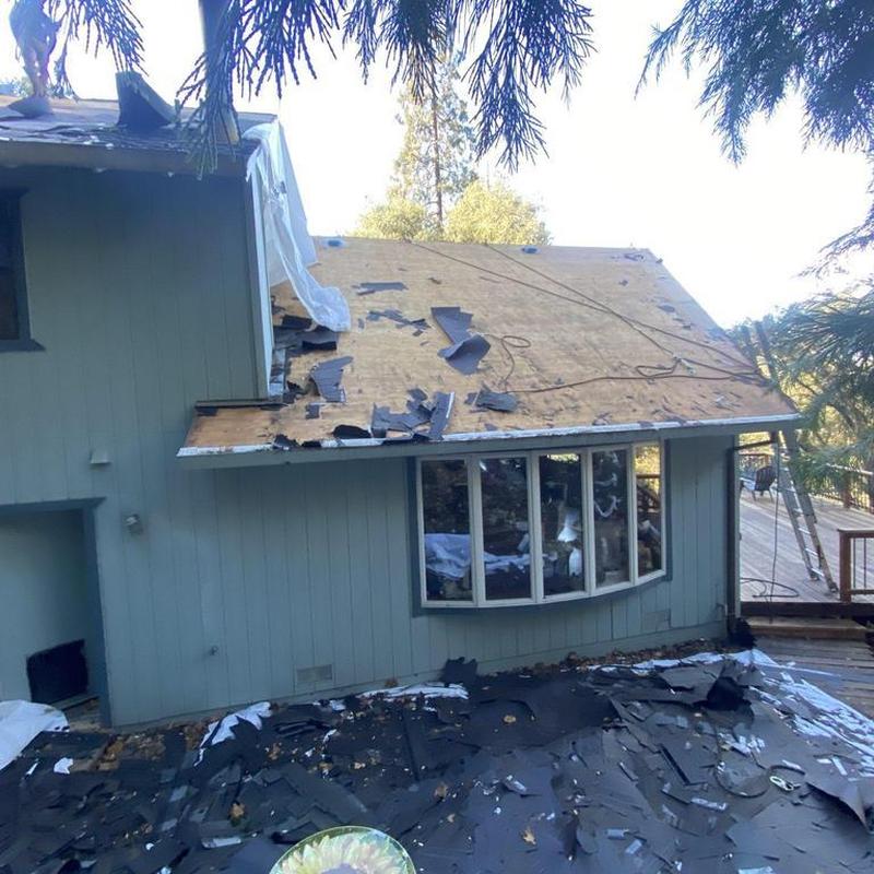 GAF roof installation with teardown debris on house