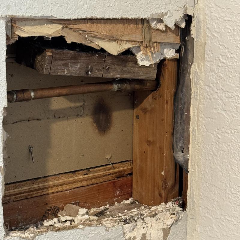 Copper water supply pipe behind drywall opening Copper water supply pipe behind drywall opening