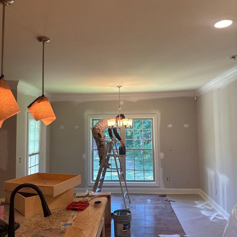 Interior lighting chandelier installation in progress