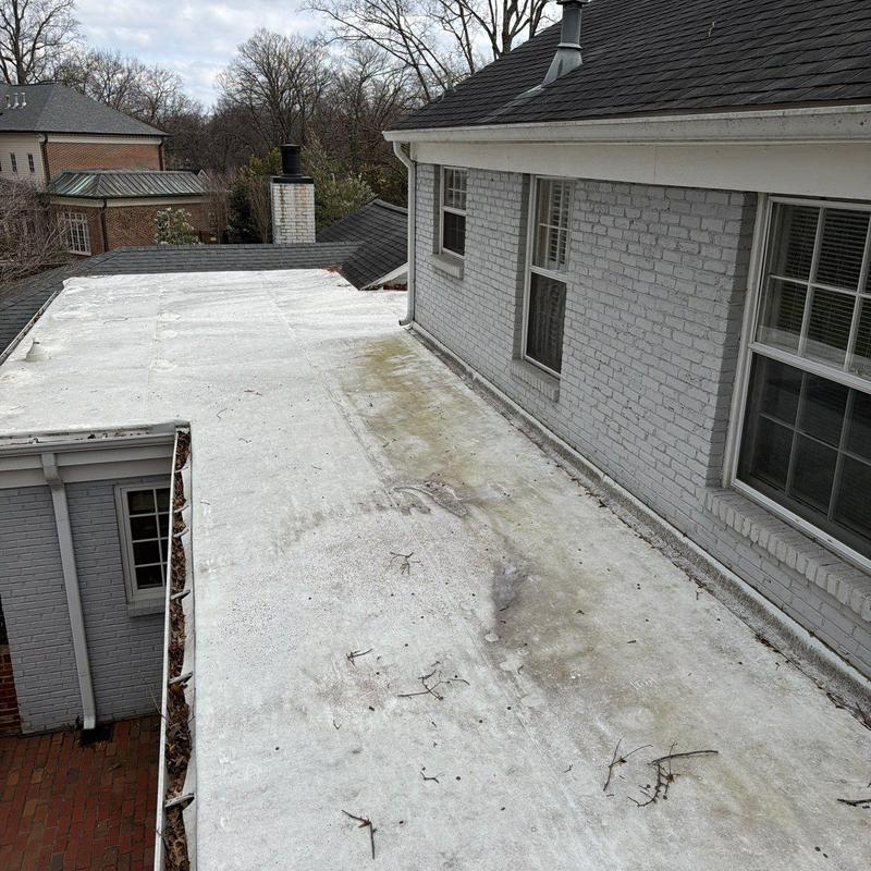 Flat roof membrane with dirt and debris buildup