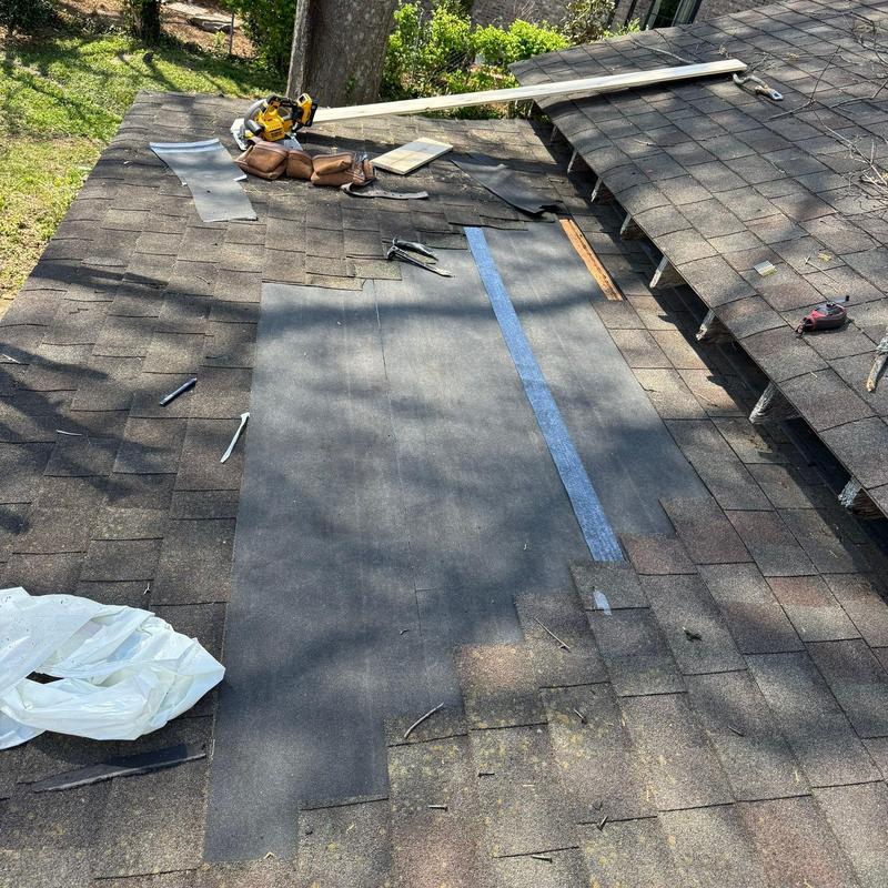 Roof shingles with underlayment installation and tools on roof
