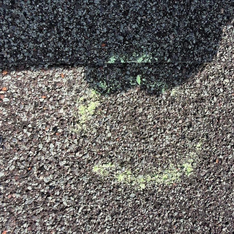 Asphalt shingle roof with hail damage marked in chalk