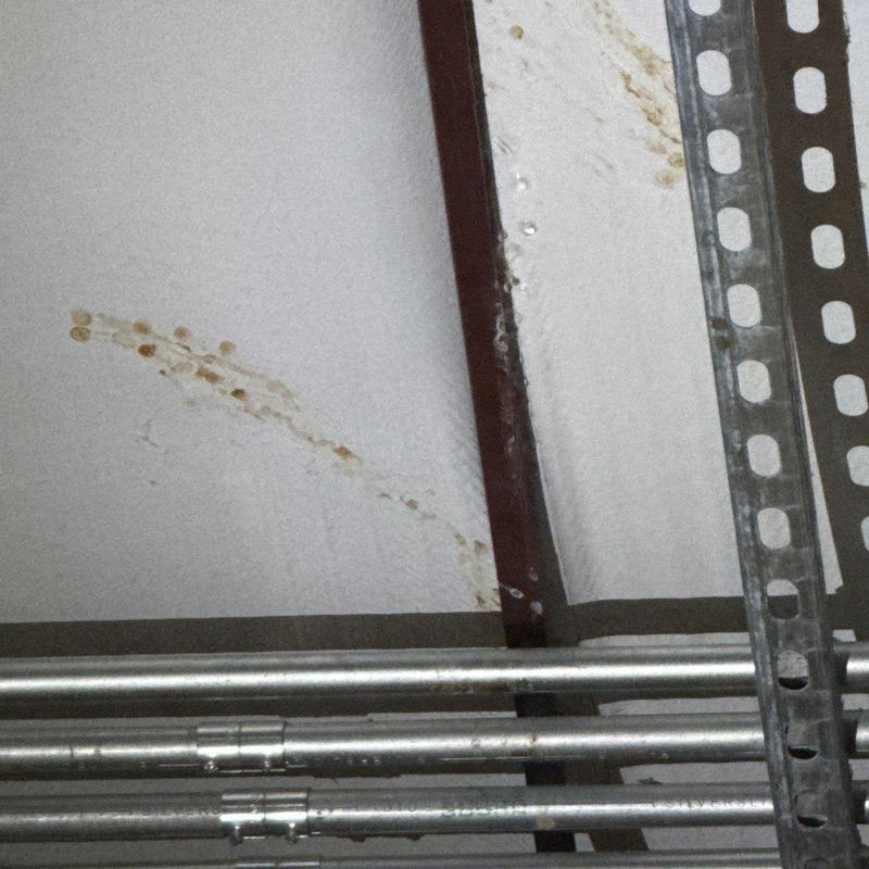 Commercial roof insulation with water stains and damage