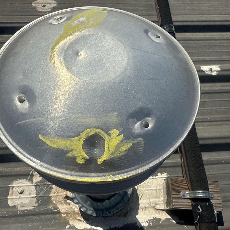 Roof vent cap with hail damage and markings on metal