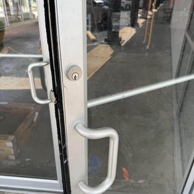 Storefront door lock with metal handle, keyhole visible Storefront door lock with metal handle, keyhole visible