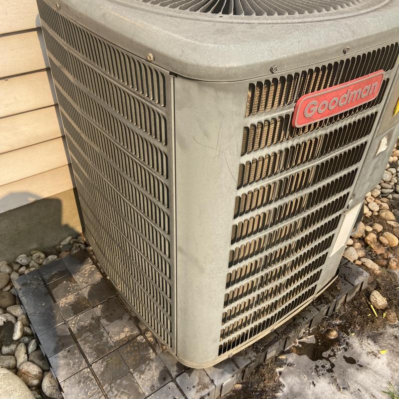 Goodman outdoor condenser unit on tiled base Goodman outdoor condenser unit on tiled base