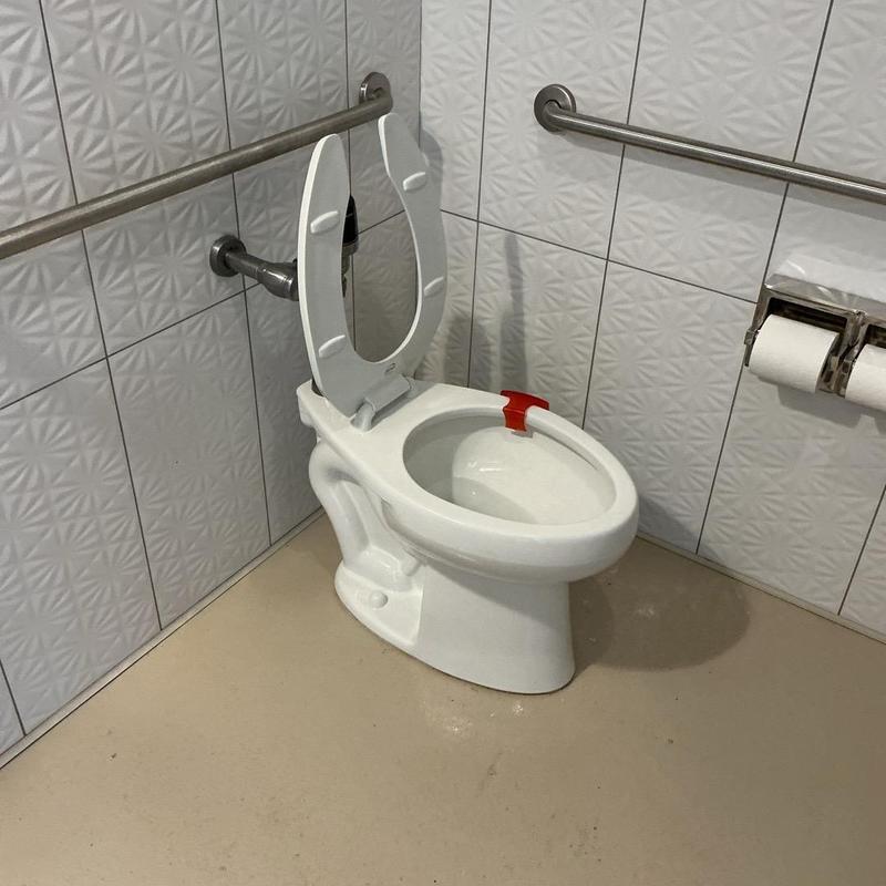 Toilet with replaced wax ring and resealed base Toilet with replaced wax ring and resealed base