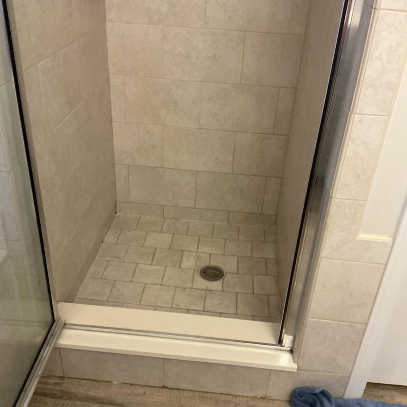 Shower drain with tiled floor and glass door Shower drain with tiled floor and glass door