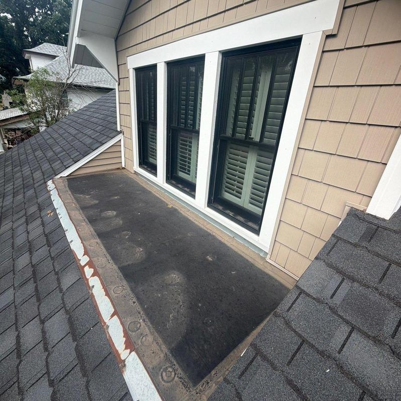 Flat roof section with rubber membrane near windows Flat roof section with rubber membrane near windows