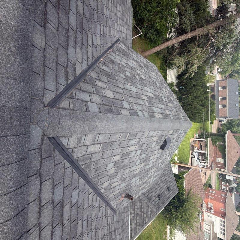 Asphalt shingle roof with ridge vent and chimney Asphalt shingle roof with ridge vent and chimney