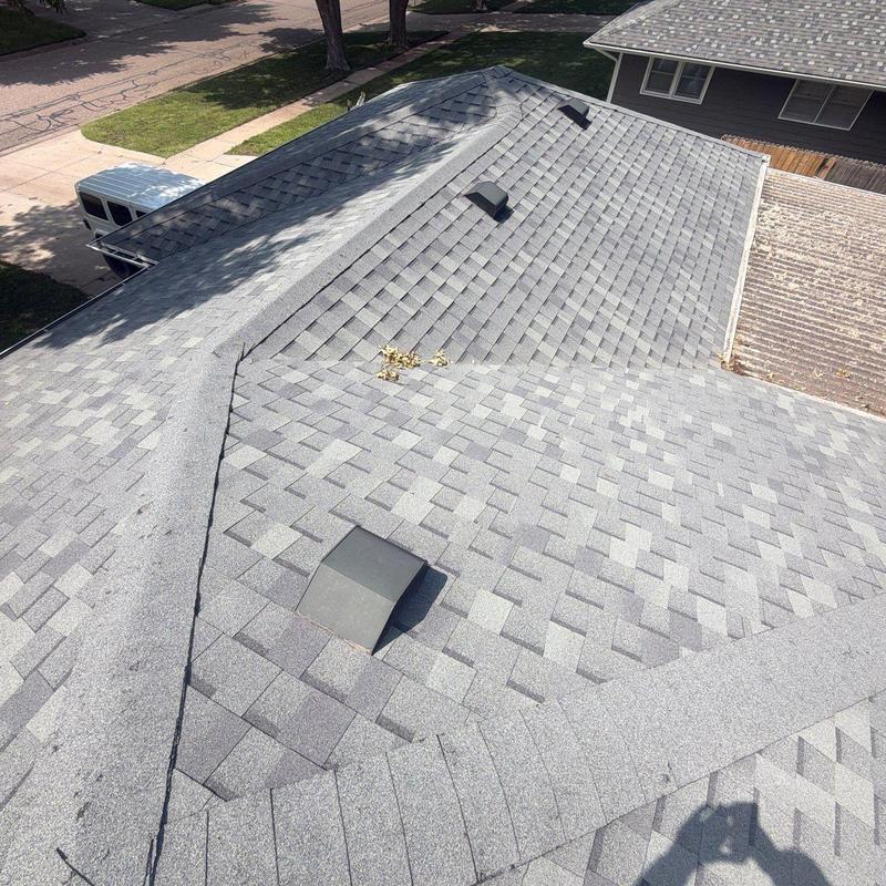 Asphalt shingle roof with vents and no damage visible Asphalt shingle roof with vents and no damage visible