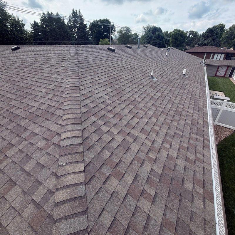 Asphalt shingle roof with ridge vents and plumbing vents Asphalt shingle roof with ridge vents and plumbing vents