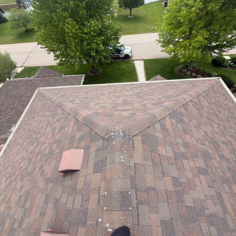 Asphalt shingle roof with ridge vent and inspection view Asphalt shingle roof with ridge vent and inspection view