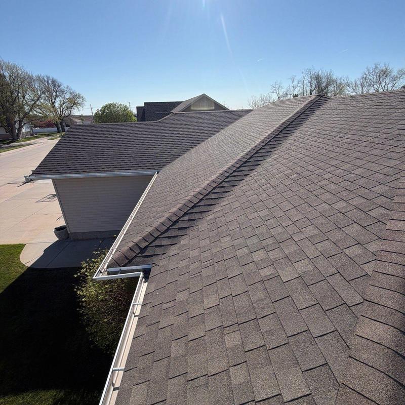Asphalt shingle roof with gutters during inspection Asphalt shingle roof with gutters during inspection