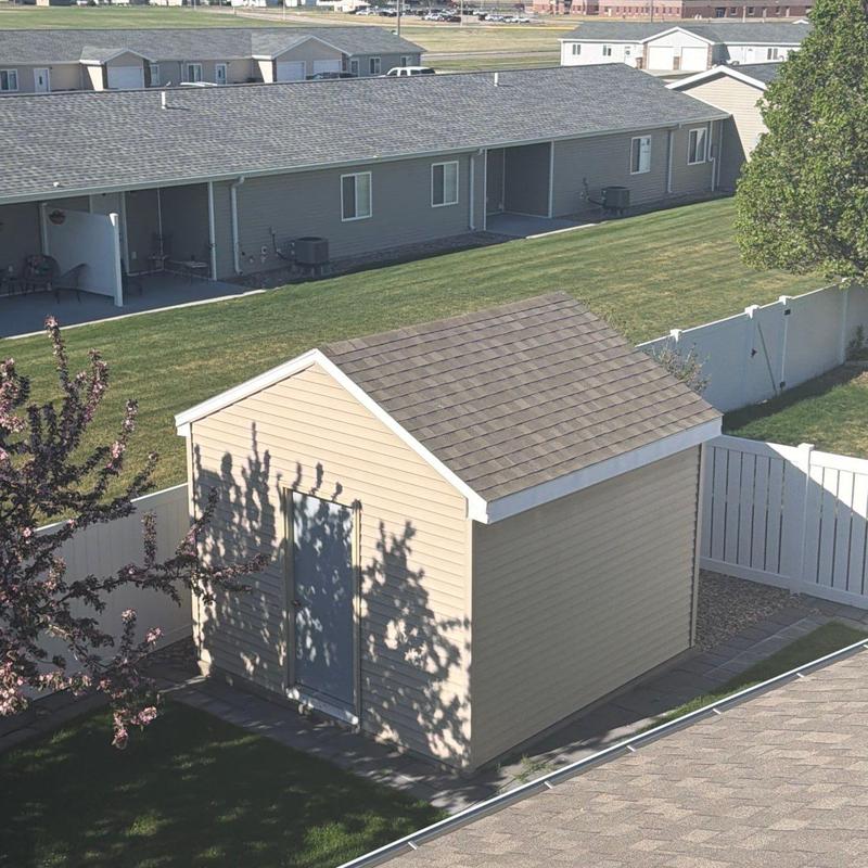 Shed roof with asphalt shingles in residential yard Shed roof with asphalt shingles in residential yard
