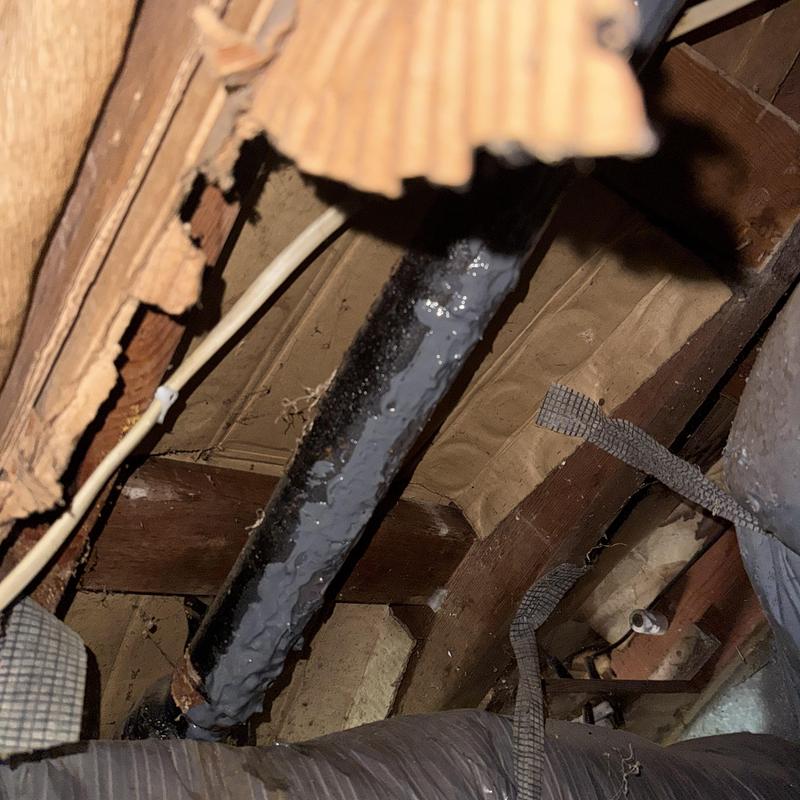 Cast iron drain pipe in crawl space showing damage Cast iron drain pipe in crawl space showing damage