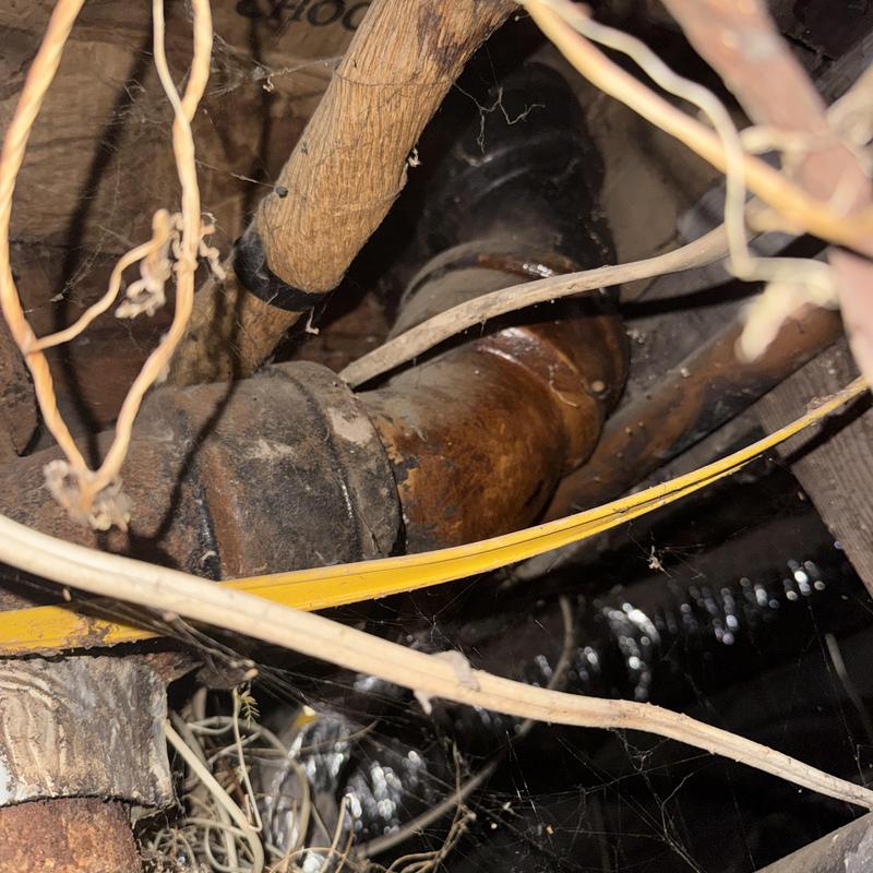 Cast iron drain pipe with cracks in crawl space Cast iron drain pipe with cracks in crawl space