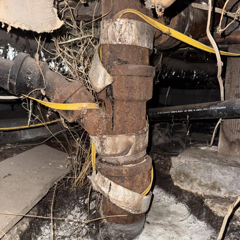 Cast iron drain pipe with cracks in crawl space Cast iron drain pipe with cracks in crawl space