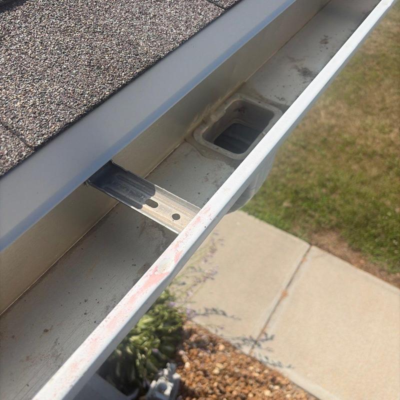 Roof gutter with downspout opening and hanger bracket Roof gutter with downspout opening and hanger bracket