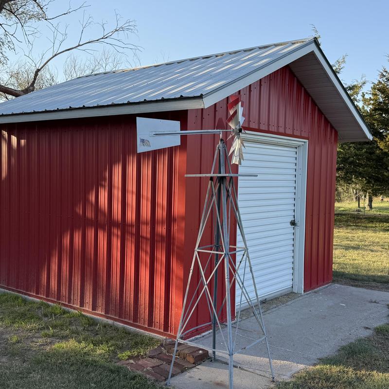 Metal roof and panel siding on red storage building Metal roof and panel siding on red storage building